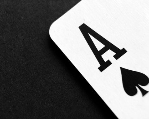 ace of spade playing card on grey surface