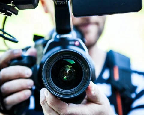 person holding canon dslr camera close up photo